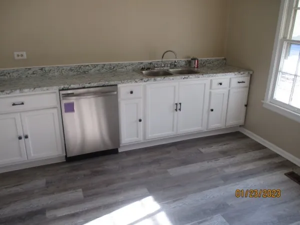 a view of a kitchen with granite countertop cabinets and sink