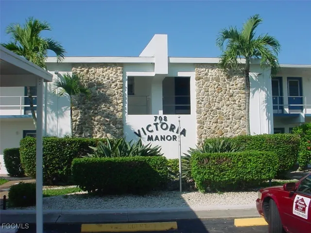 front view of a house with potted plants