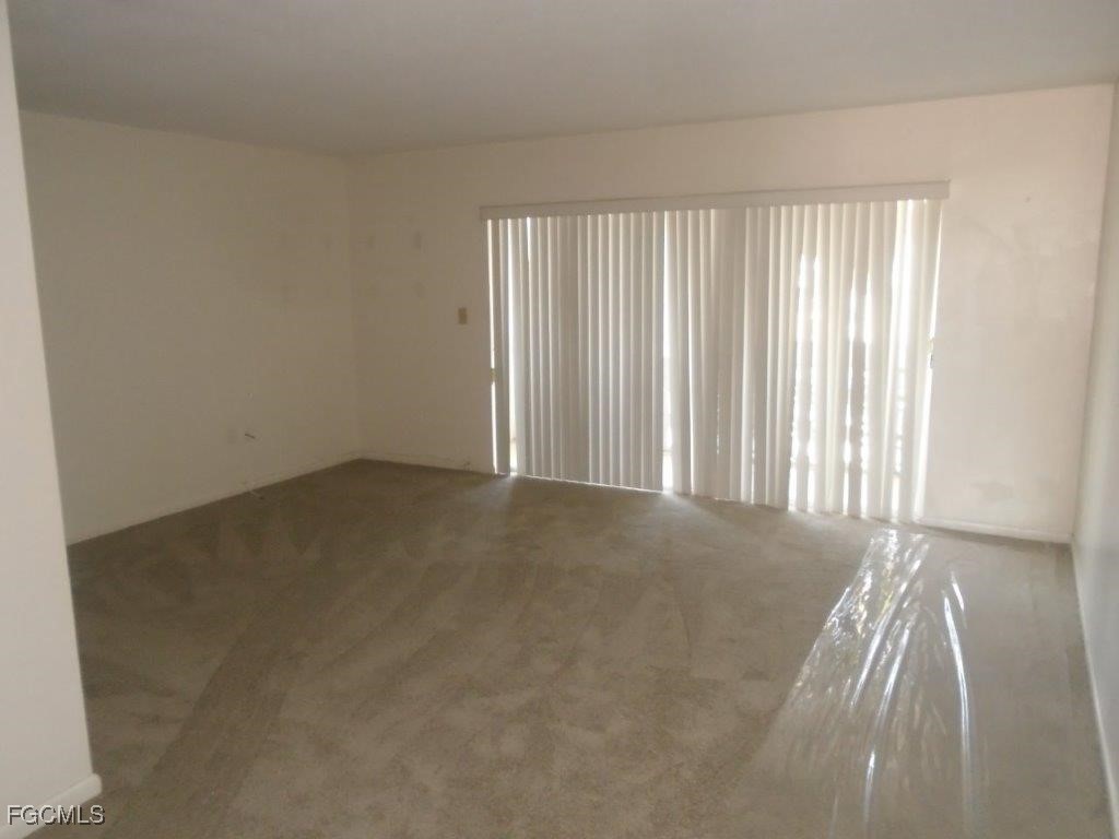708 Victoria Drive, Unit 206 Cape Coral, FL 33904 - Photo 11 of 17 an empty room with windows