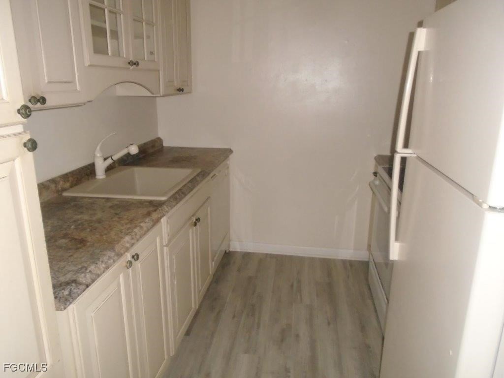 708 Victoria Drive, Unit 206 Cape Coral, FL 33904 - Photo 12 of 17 a bathroom with a granite countertop sink and a granite top