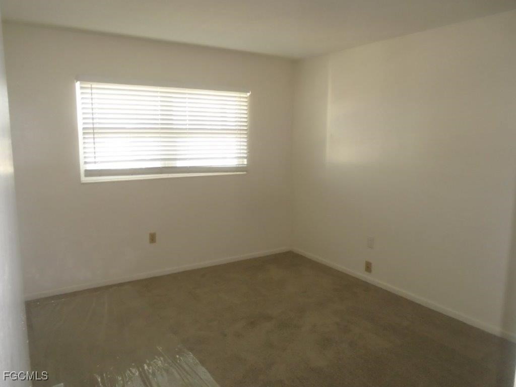 708 Victoria Drive, Unit 206 Cape Coral, FL 33904 - Photo 13 of 17 an empty room with a window