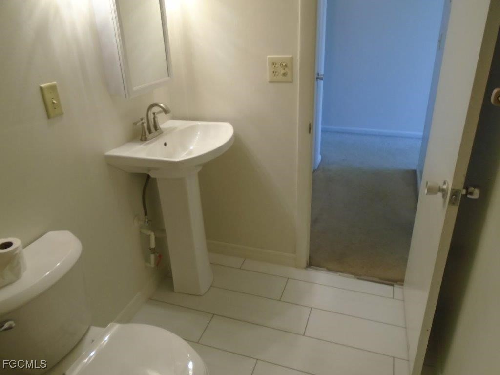 708 Victoria Drive, Unit 206 Cape Coral, FL 33904 - Photo 15 of 17 a bathroom with a sink toilet and shower
