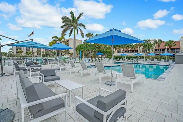 a view of swimming pool with outdoor seating and plants