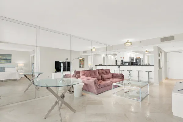 a living room with furniture and kitchen view