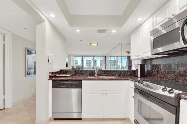 a kitchen with stainless steel appliances granite countertop a stove and a sink