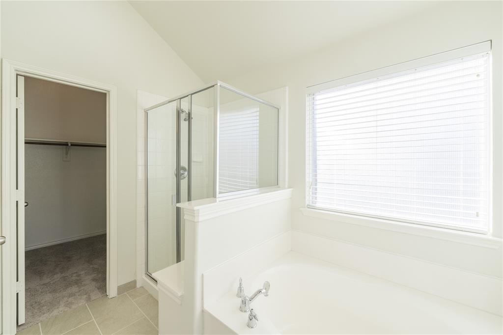 1627 Balboa Lane Allen, TX 75002 - Photo 15 of 23 a bathroom with a bathtub and a shower