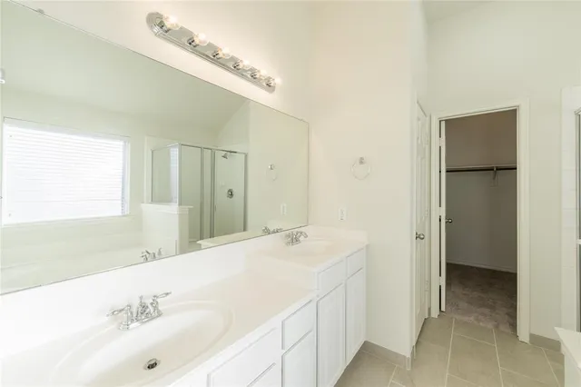 a bathroom with a bathtub sink and mirror