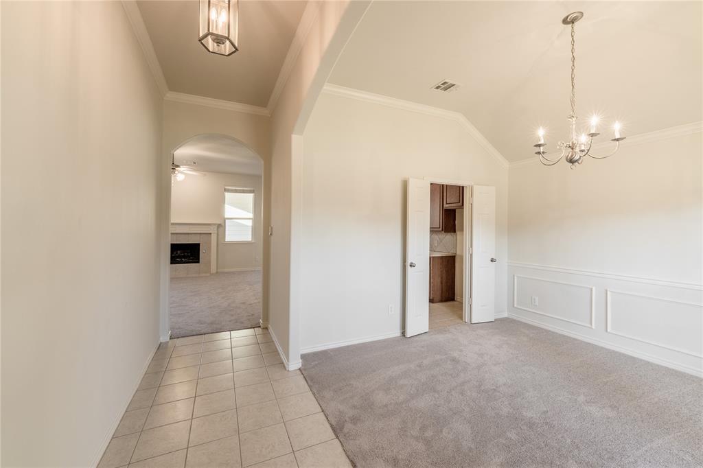 1627 Balboa Lane Allen, TX 75002 - Photo 3 of 23 a view of a hallway with wooden floor and chandelier