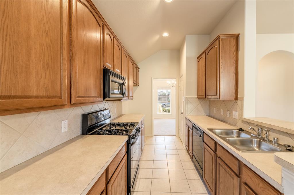1627 Balboa Lane Allen, TX 75002 - Photo 10 of 23 a kitchen with stainless steel appliances a sink stove and cabinets