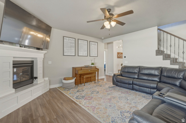 836 South 250 West Vernal, UT 84078 - Photo 20 of 56 Living room with wood finished floors, a ceiling fan, and a glass covered fireplace