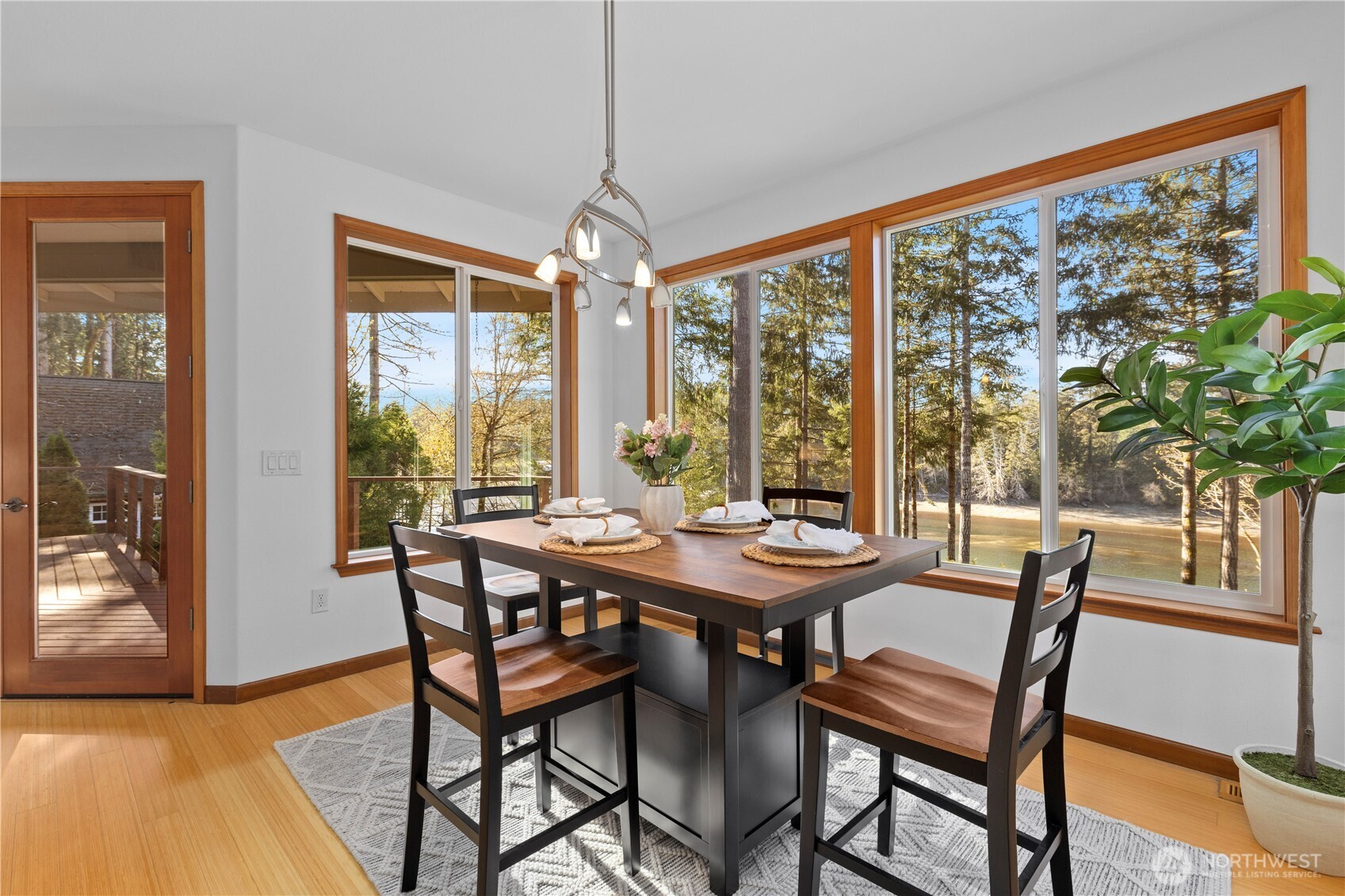 730 Southeast Nelson Road Shelton, WA 98584 - Photo 17 of 40 a view of a dining room with furniture large windows and wooden floor