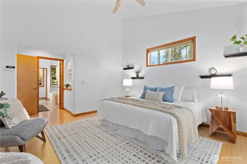 a bedroom with a bed and wooden floor