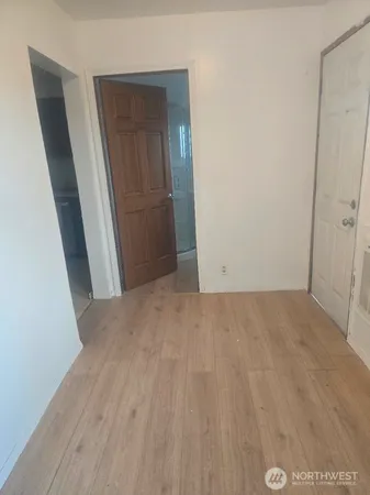 a view of hallway with wooden floor