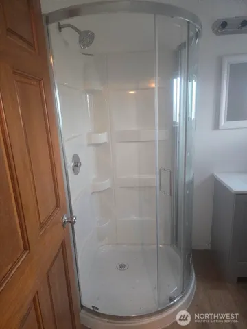 a bathroom with a glass shower door