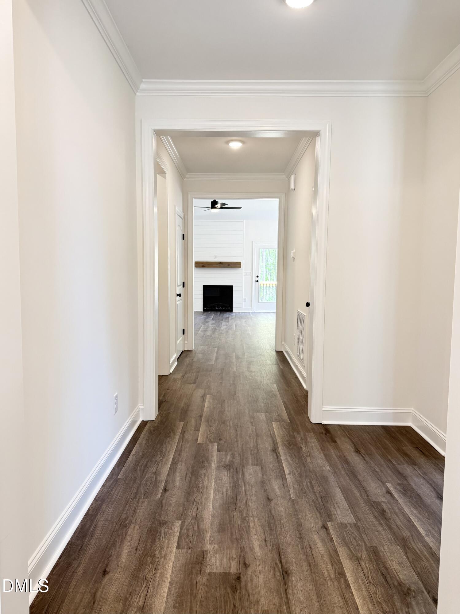 10300 Stallings Road Spring Hope, NC 27882 - Photo 4 of 36 a view of a hallway with wooden floor and a fireplace