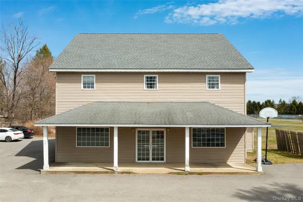 a front view of a house with a garden and garage