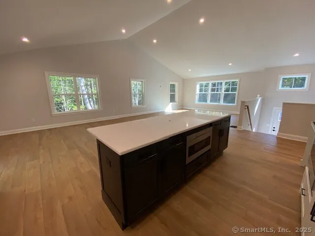 a kitchen with a stove and wooden floor