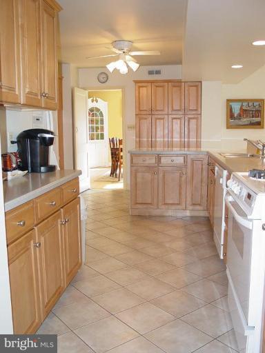6904 Avondale Road Baltimore, MD 21212 - Photo 8 of 30 a kitchen with stainless steel appliances granite countertop a stove a sink and a granite counter tops