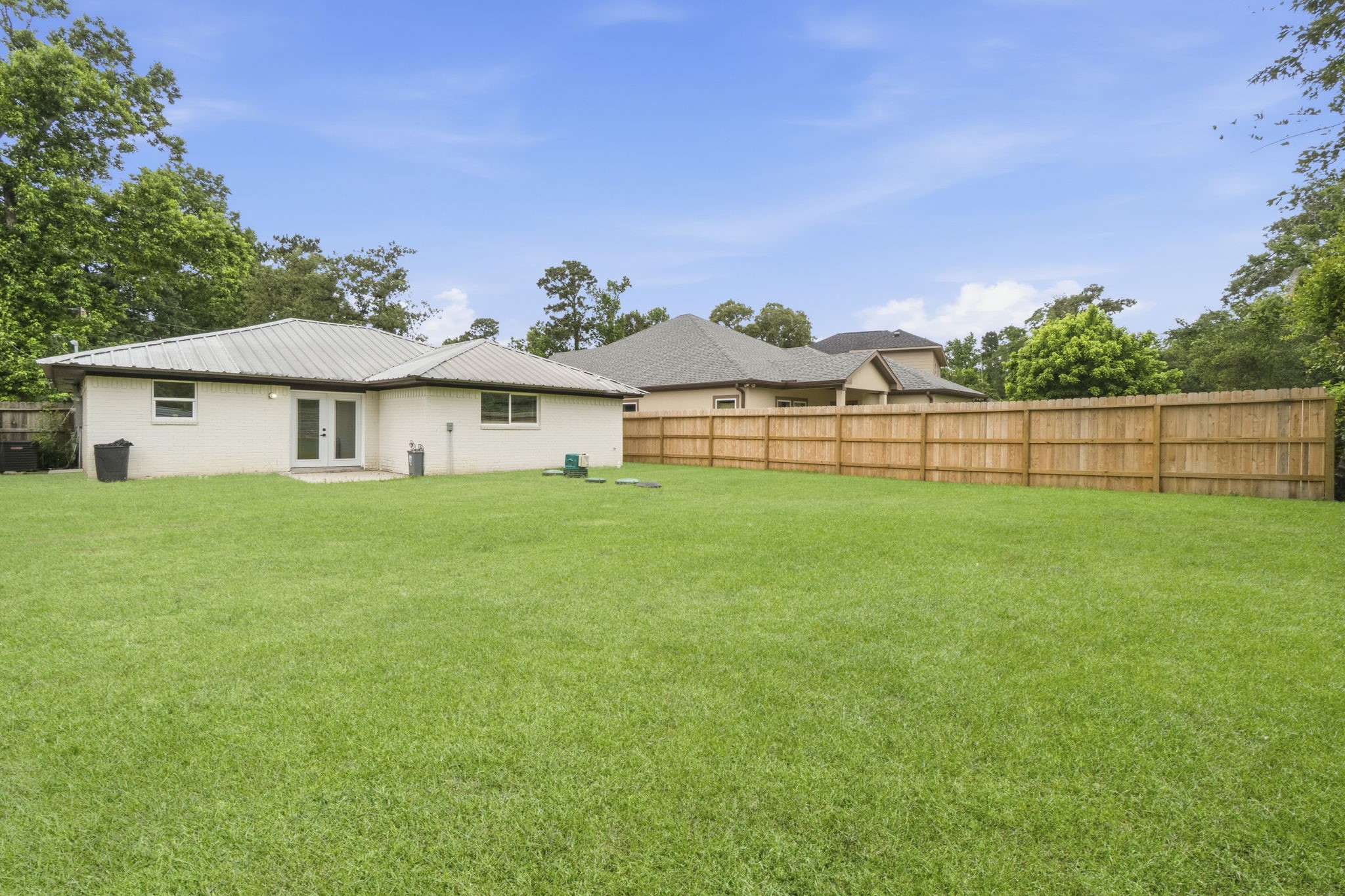 14850 Coaltown Road Willis, TX 77378 - Photo 29 of 41 Large backyard featuring a spacious lawn, privacy fencing, and ample room for outdoor activities and gatherings.