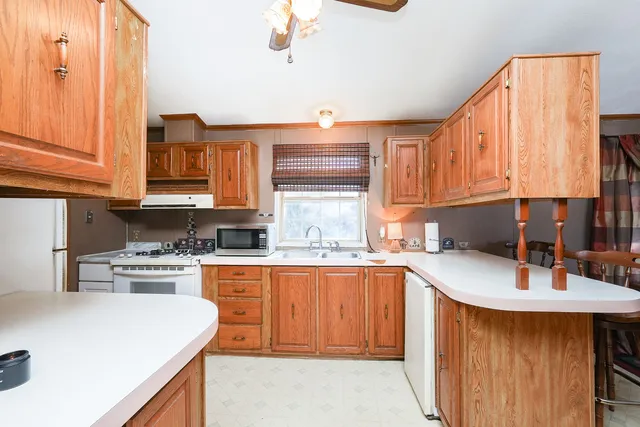 a kitchen with a sink appliances and cabinets