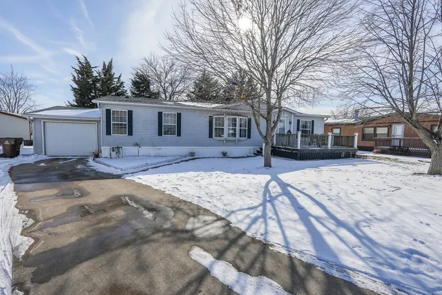 a view of a yard covered with snow in front of house