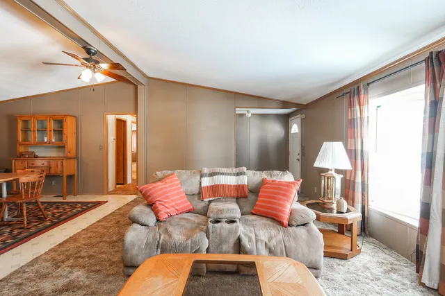 a living room with furniture and a chandelier