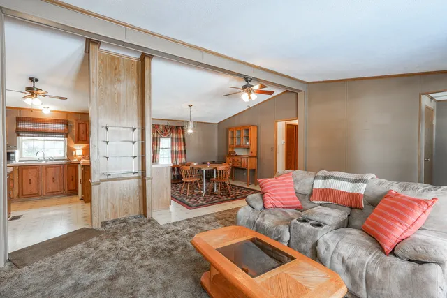 a dining room with furniture a chandelier and window