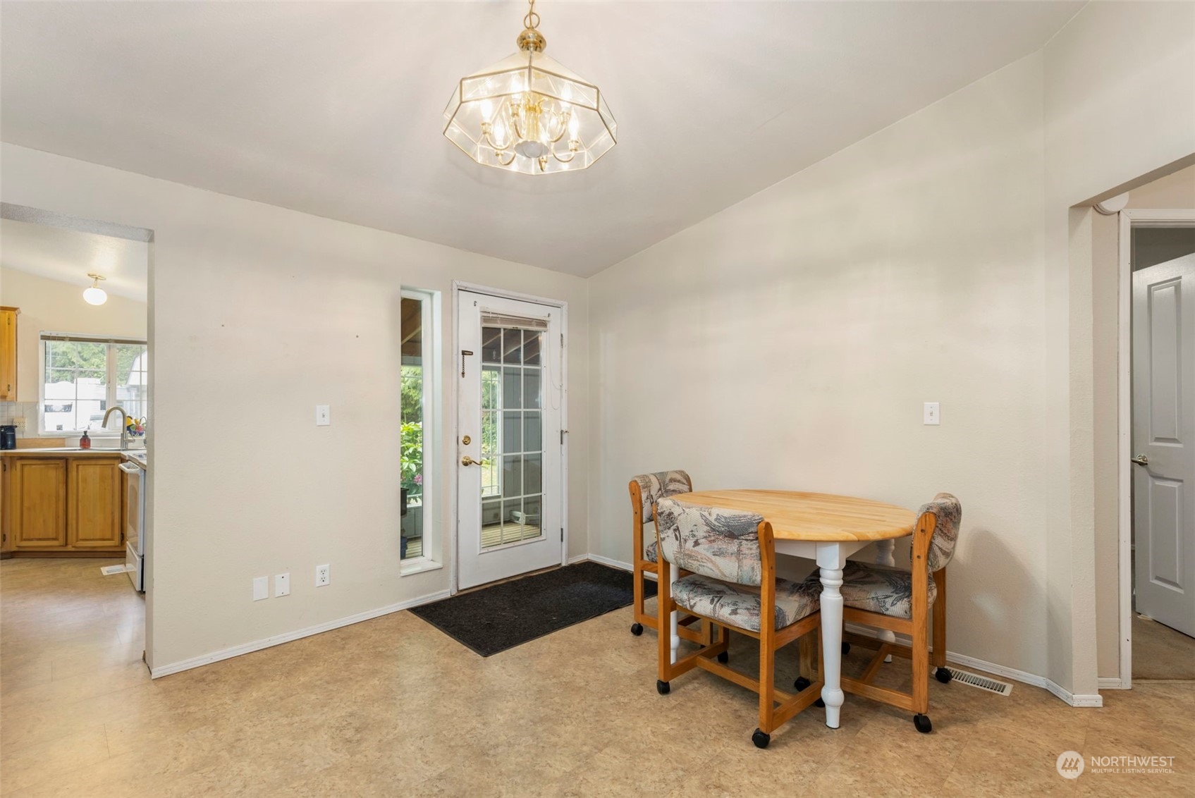 2123 East Quilcene Road Quilcene, WA 98376 - Photo 12 of 37 a view of a dining room with furniture and a chandelier