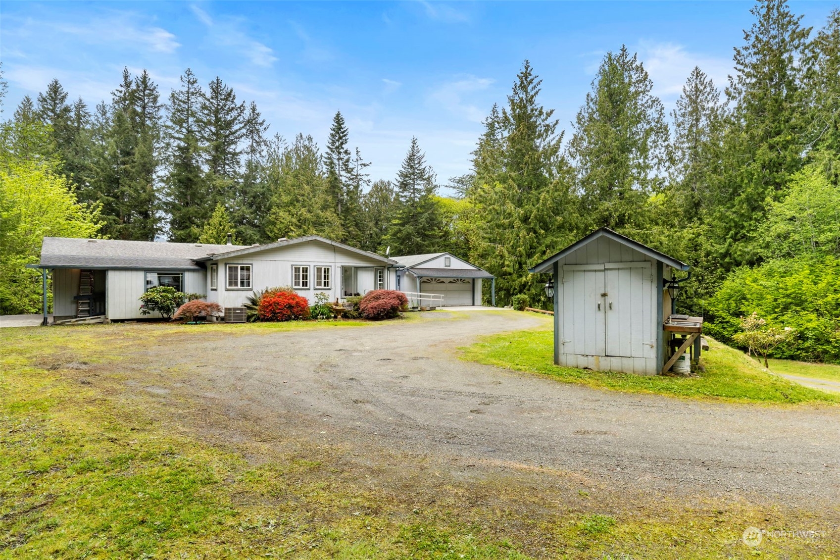 2123 East Quilcene Road Quilcene, WA 98376 - Photo 2 of 37 a front view of a house with a yard and trees