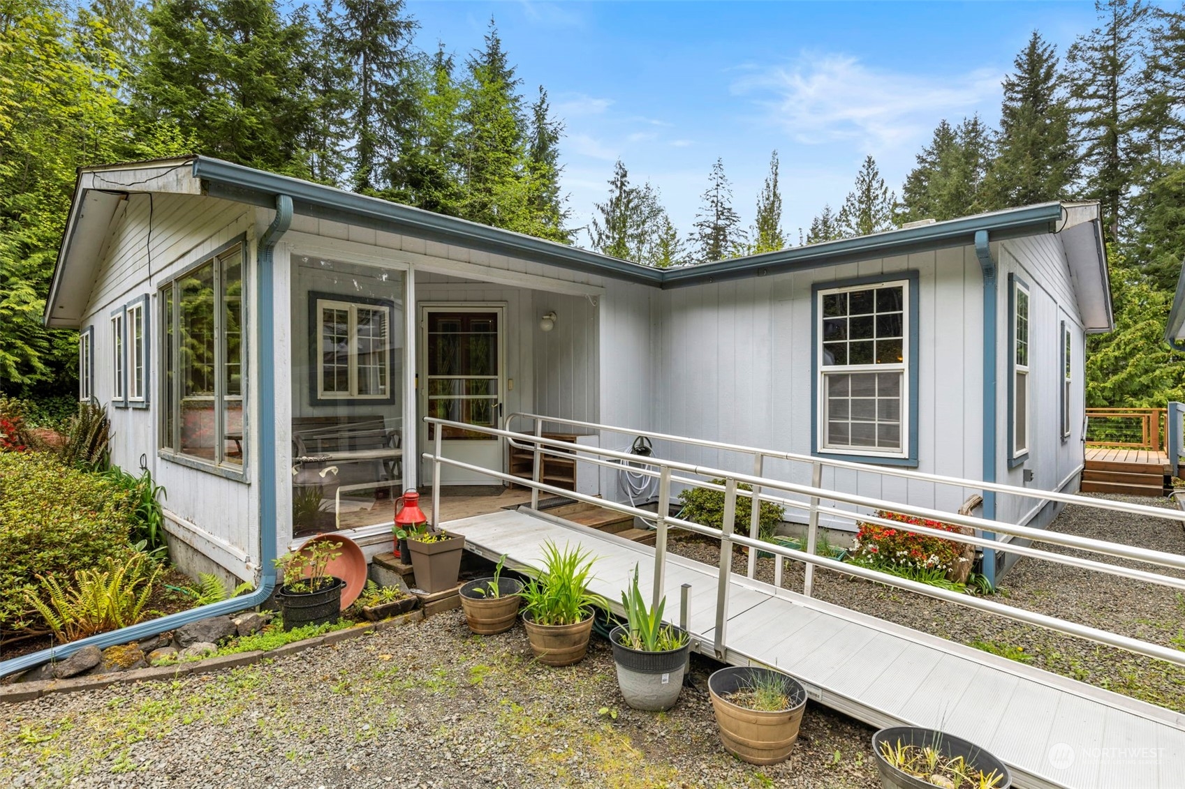 2123 East Quilcene Road Quilcene, WA 98376 - Photo 4 of 37 a view of a house with a patio and a yard