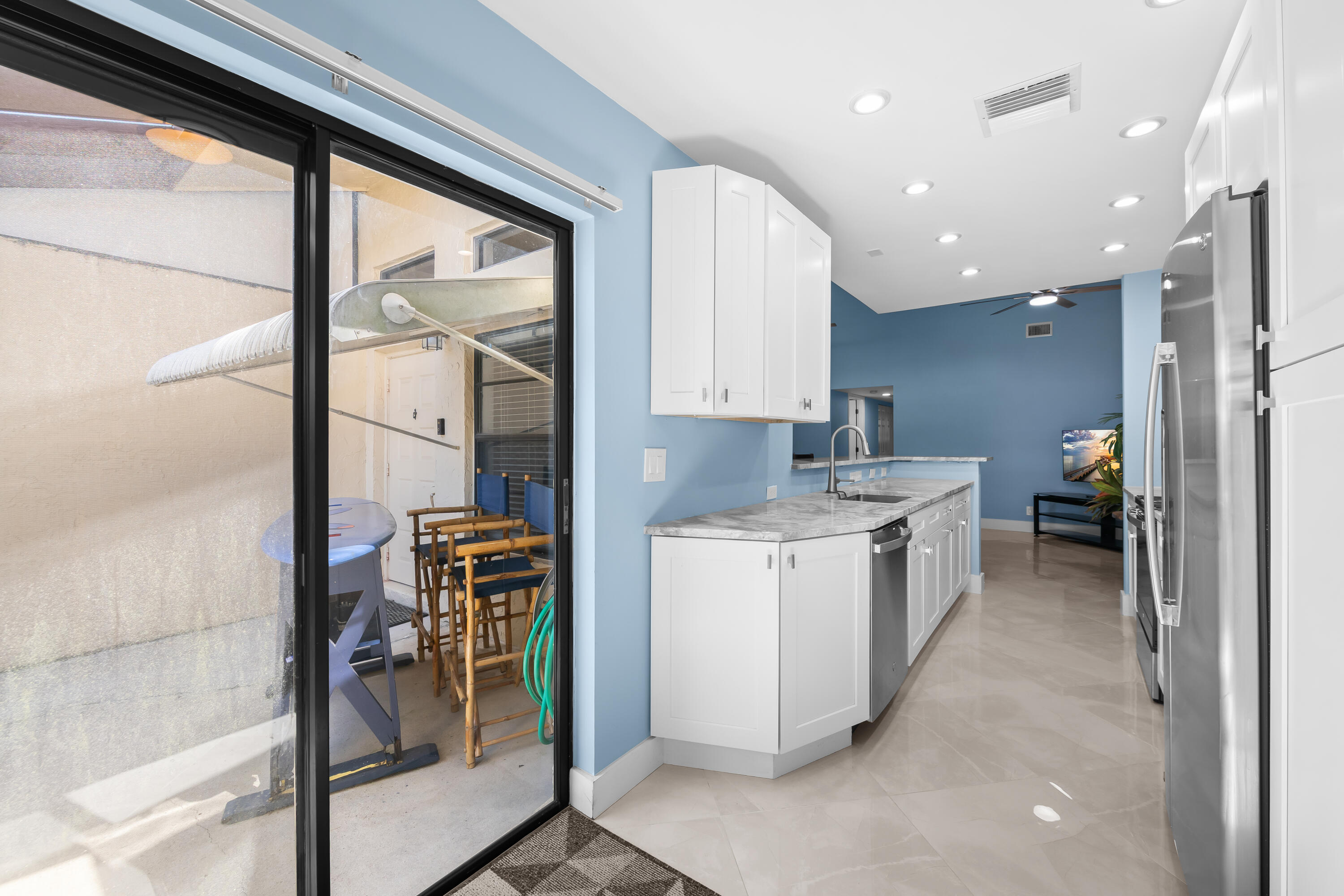 14079 Nesting Way, Unit B Delray Beach, FL 33484 - Photo 12 of 26 a kitchen with a sink and cabinets