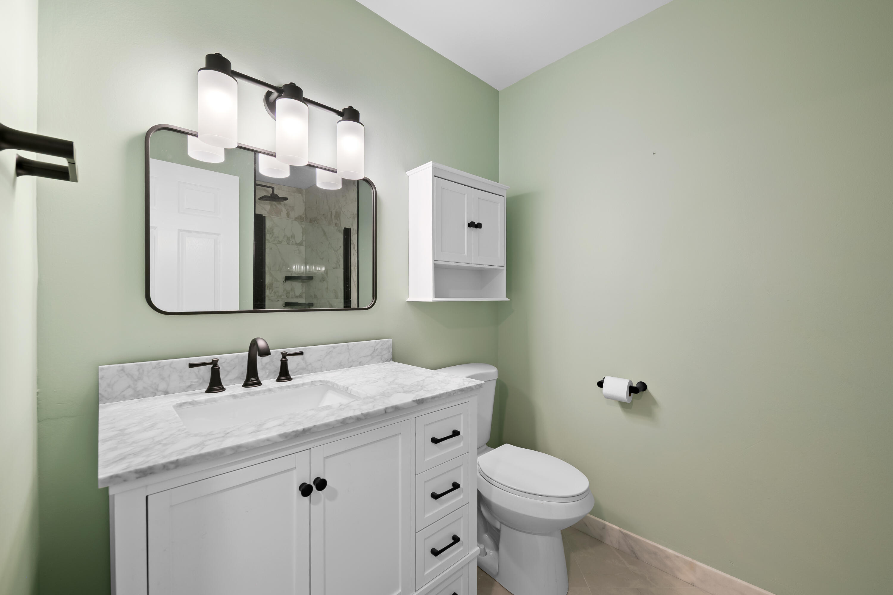 14079 Nesting Way, Unit B Delray Beach, FL 33484 - Photo 14 of 26 a bathroom with a granite countertop toilet sink and mirror