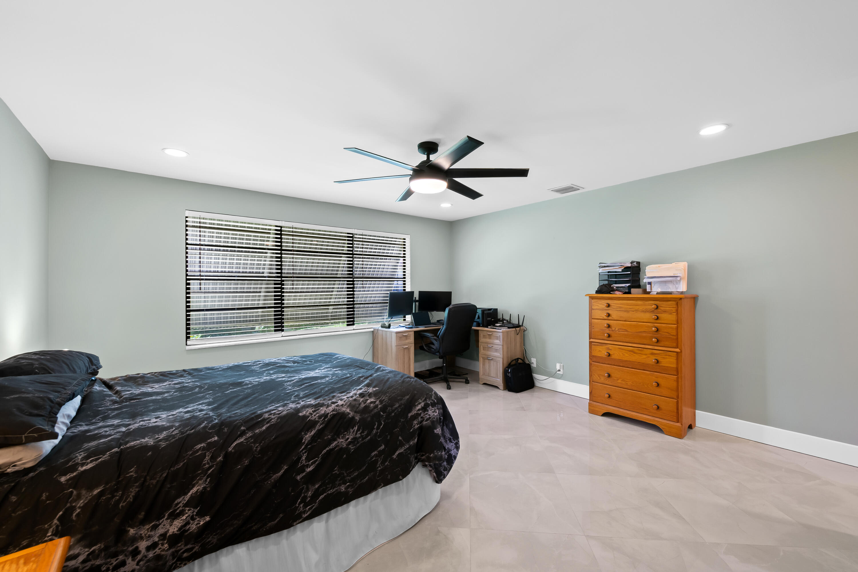 14079 Nesting Way, Unit B Delray Beach, FL 33484 - Photo 18 of 26 a bedroom with a bed and a ceiling fan