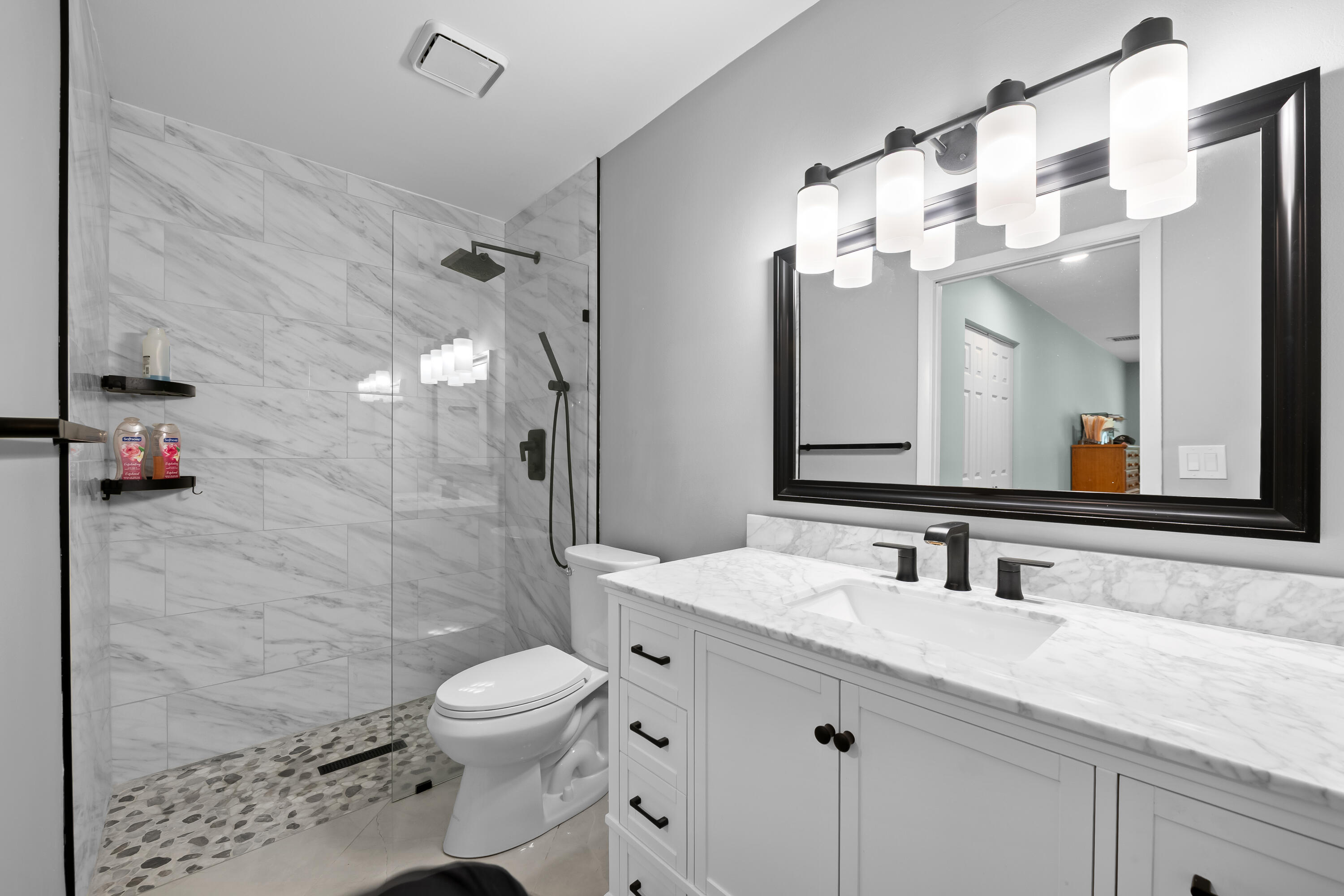 14079 Nesting Way, Unit B Delray Beach, FL 33484 - Photo 22 of 26 a bathroom with a sink a toilet and shower