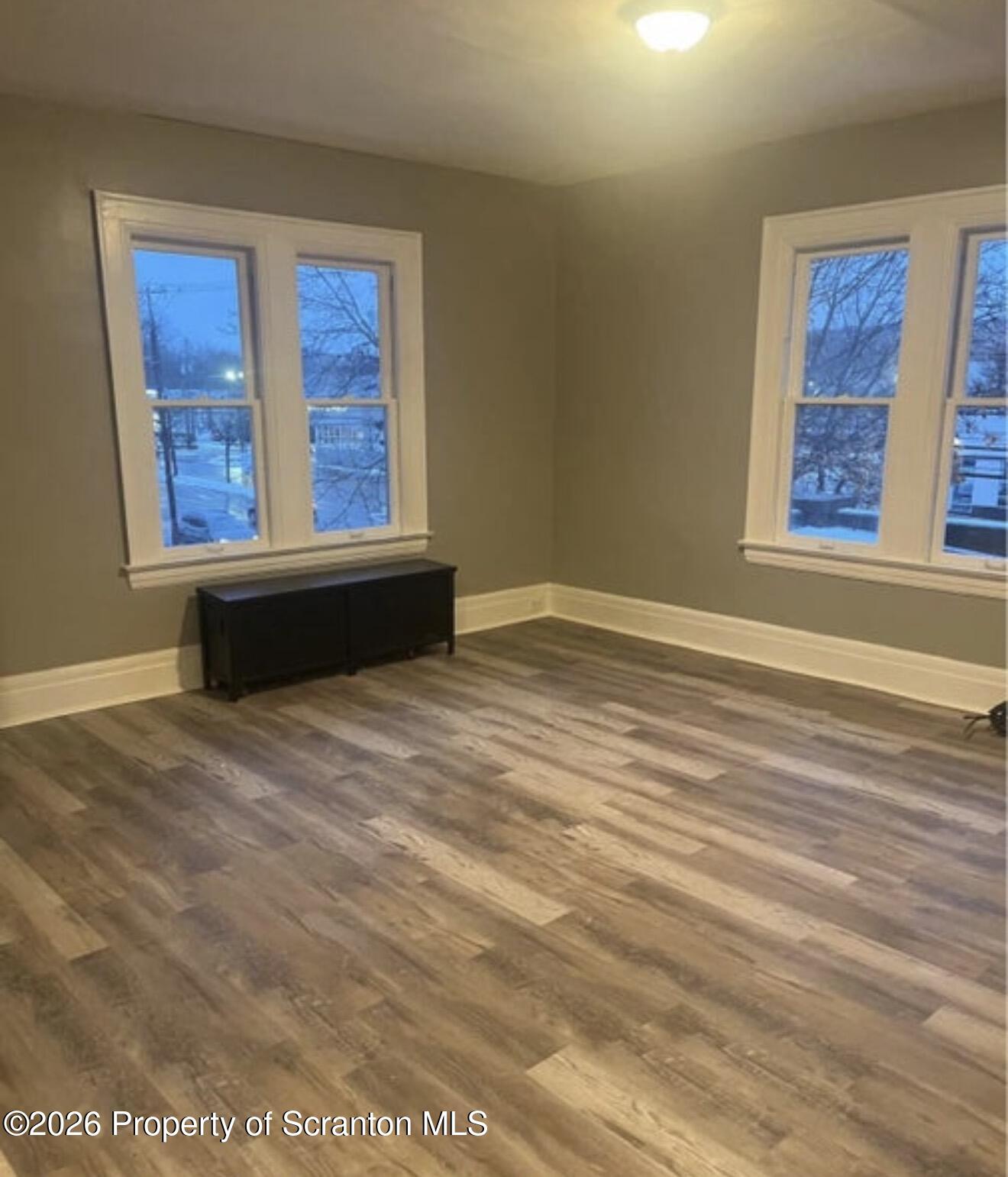 85 Main Street Olyphant, PA 18447 - Photo 12 of 29 a view of an empty room with wooden floor and a window