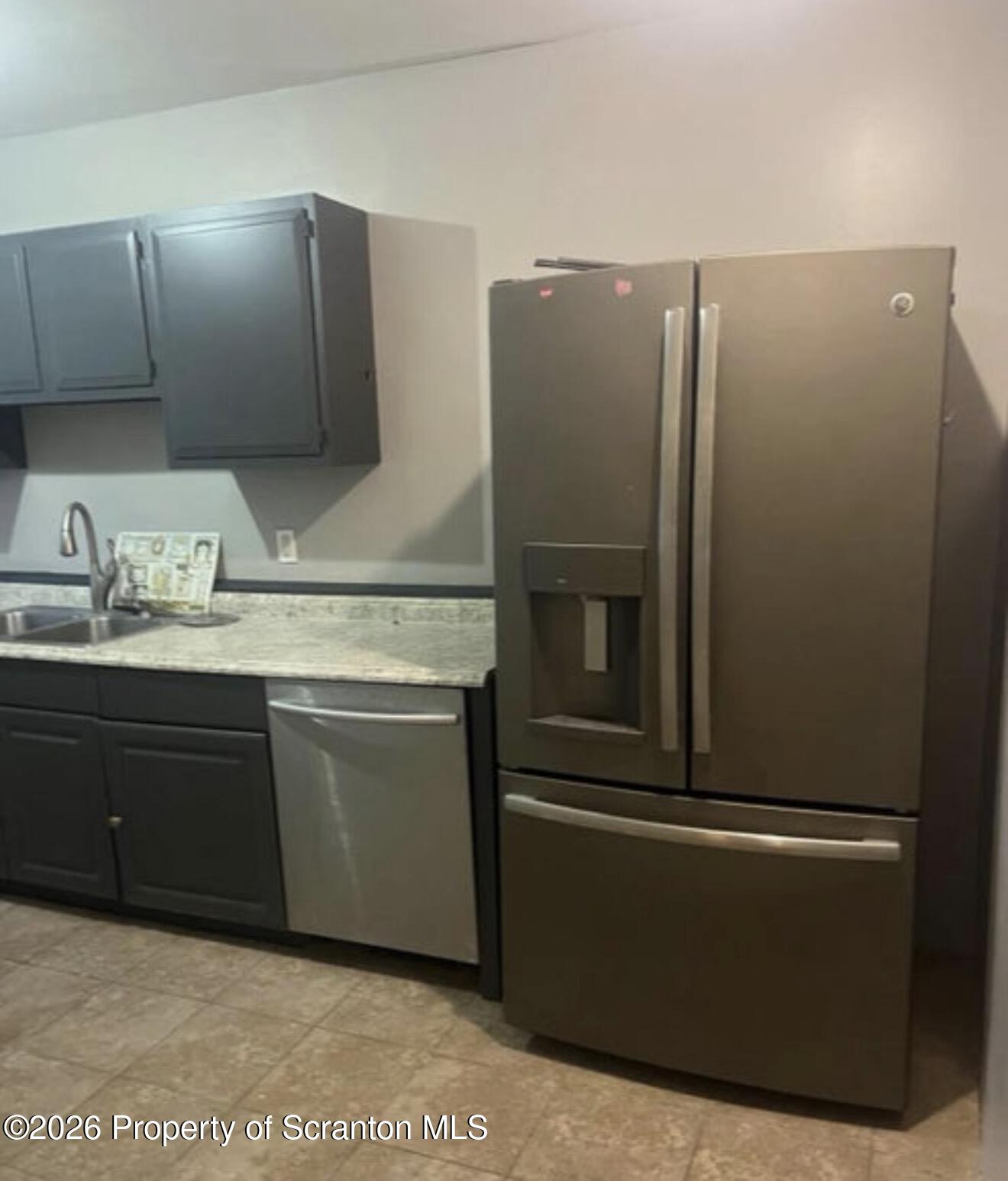 85 Main Street Olyphant, PA 18447 - Photo 14 of 29 a kitchen with stainless steel appliances granite countertop a refrigerator and a sink