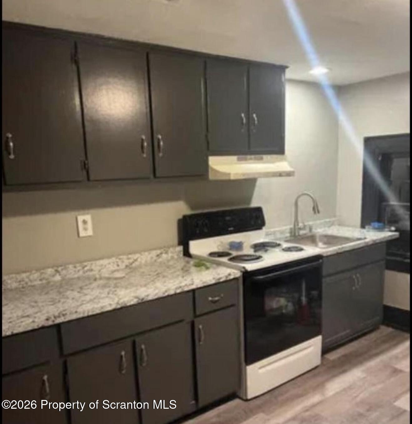 85 Main Street Olyphant, PA 18447 - Photo 18 of 29 a kitchen with stainless steel appliances granite countertop a sink stove and cabinets
