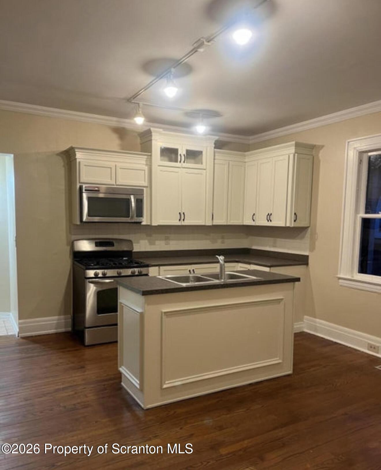 85 Main Street Olyphant, PA 18447 - Photo 2 of 29 a kitchen with stainless steel appliances granite countertop a stove a sink and a microwave