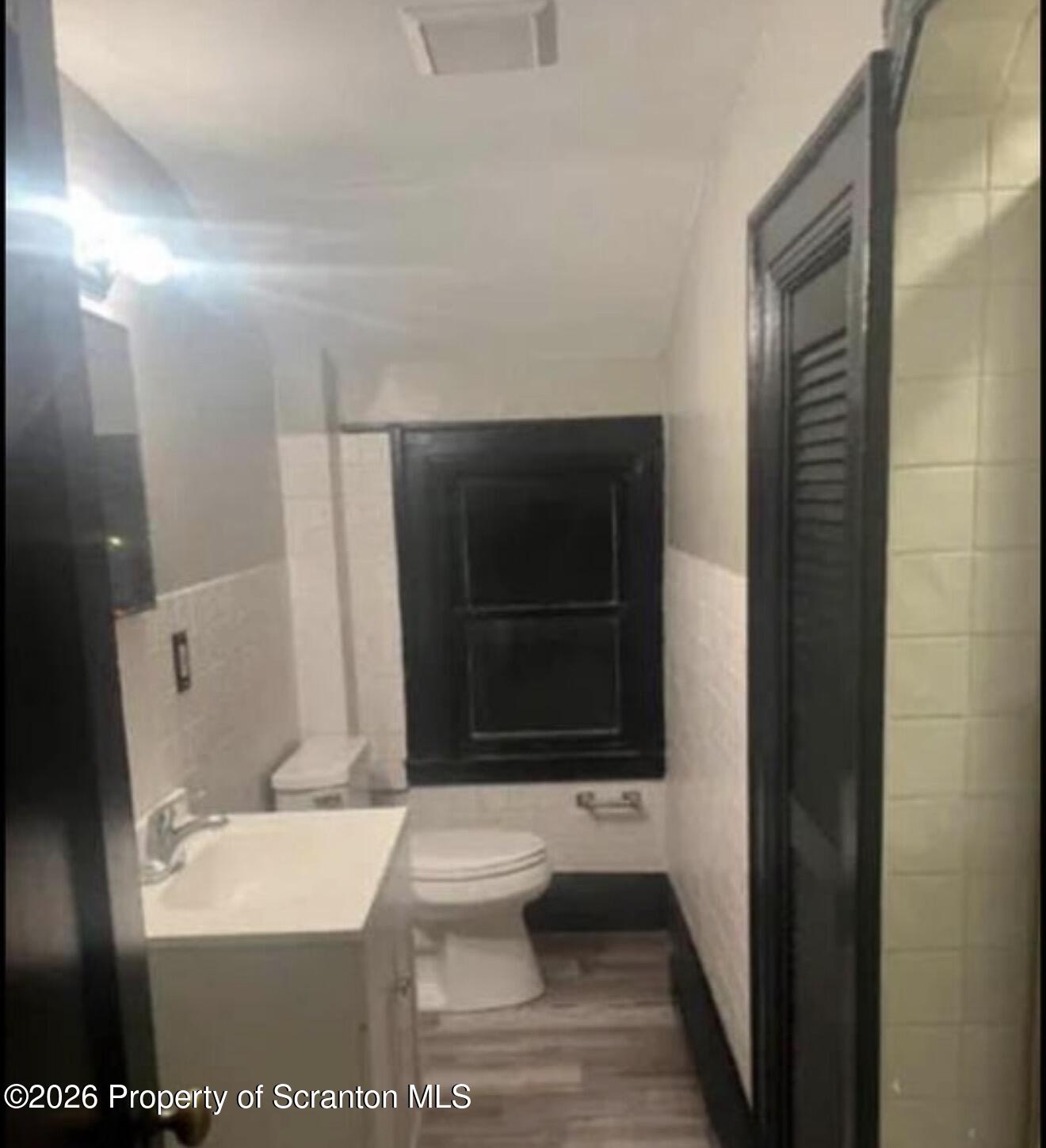 85 Main Street Olyphant, PA 18447 - Photo 22 of 29 a bathroom with a toilet a sink and mirror