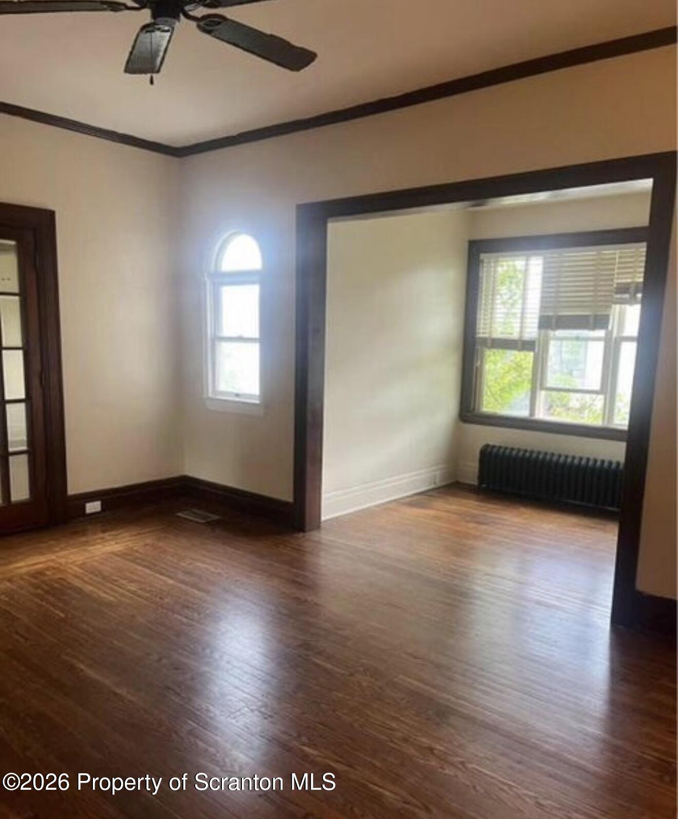 85 Main Street Olyphant, PA 18447 - Photo 27 of 29 an empty room with wooden floor and windows