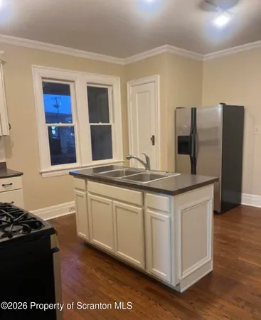 a kitchen with stainless steel appliances granite countertop a stove and a refrigerator