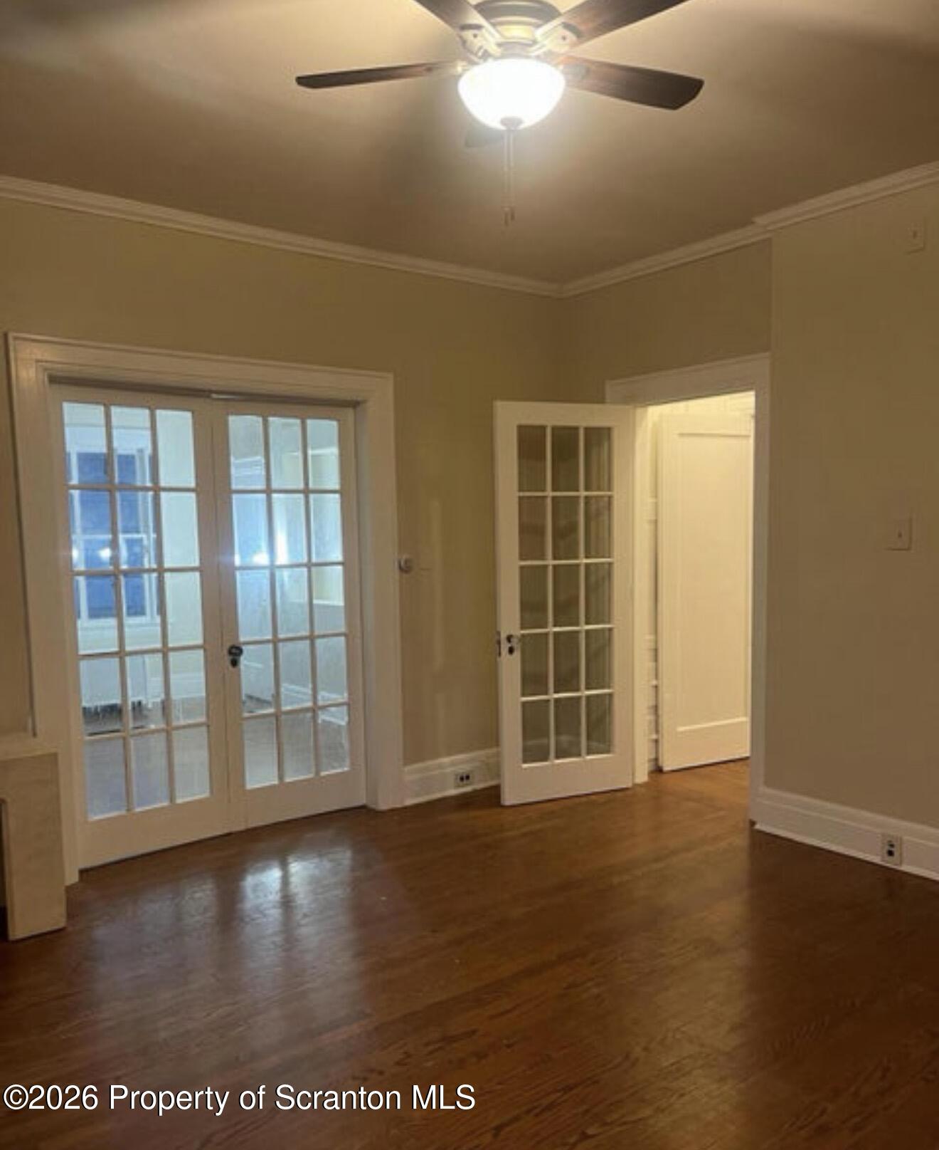 85 Main Street Olyphant, PA 18447 - Photo 5 of 29 an empty room with wooden floor and windows