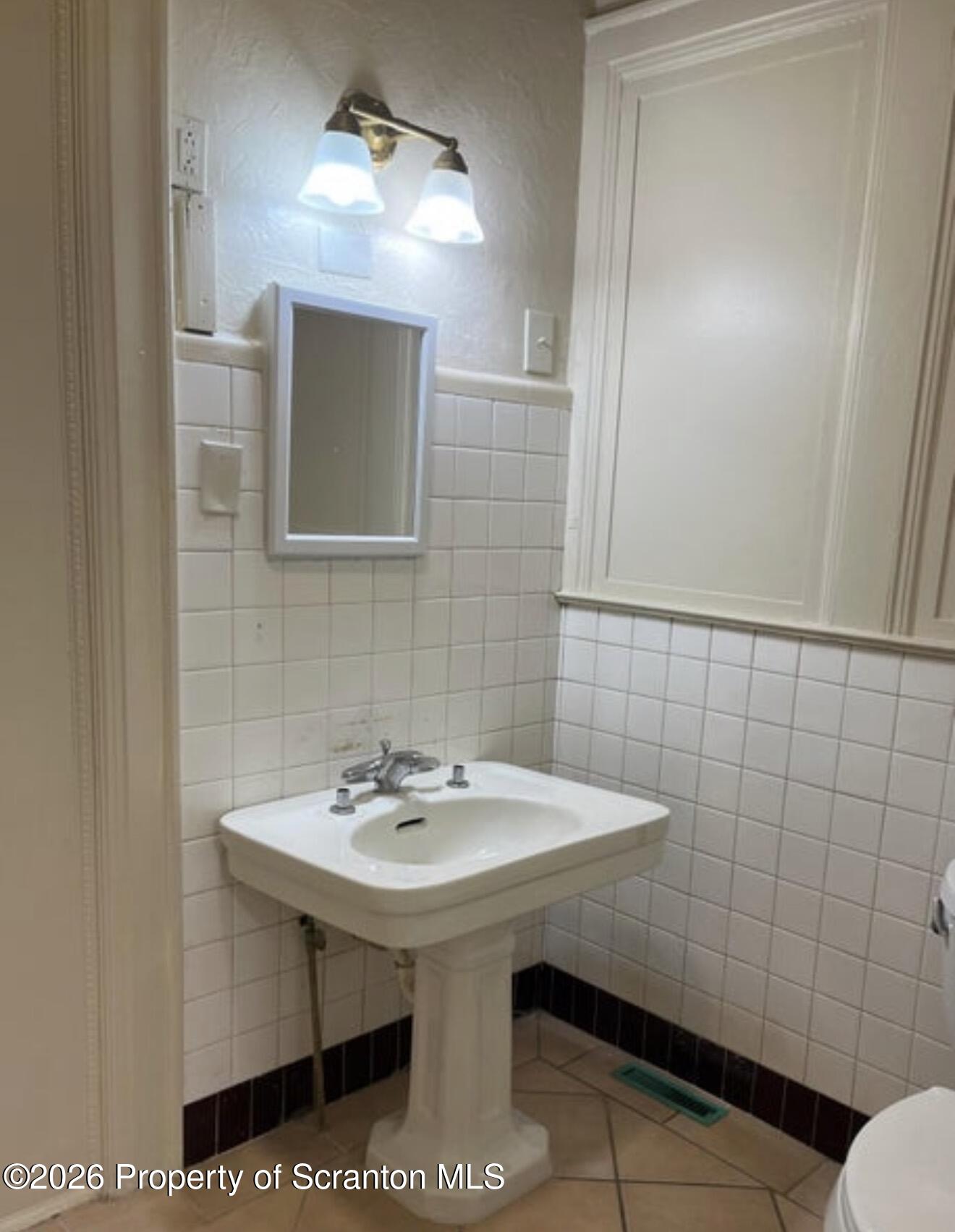 85 Main Street Olyphant, PA 18447 - Photo 9 of 29 a bathroom with a sink and a mirror