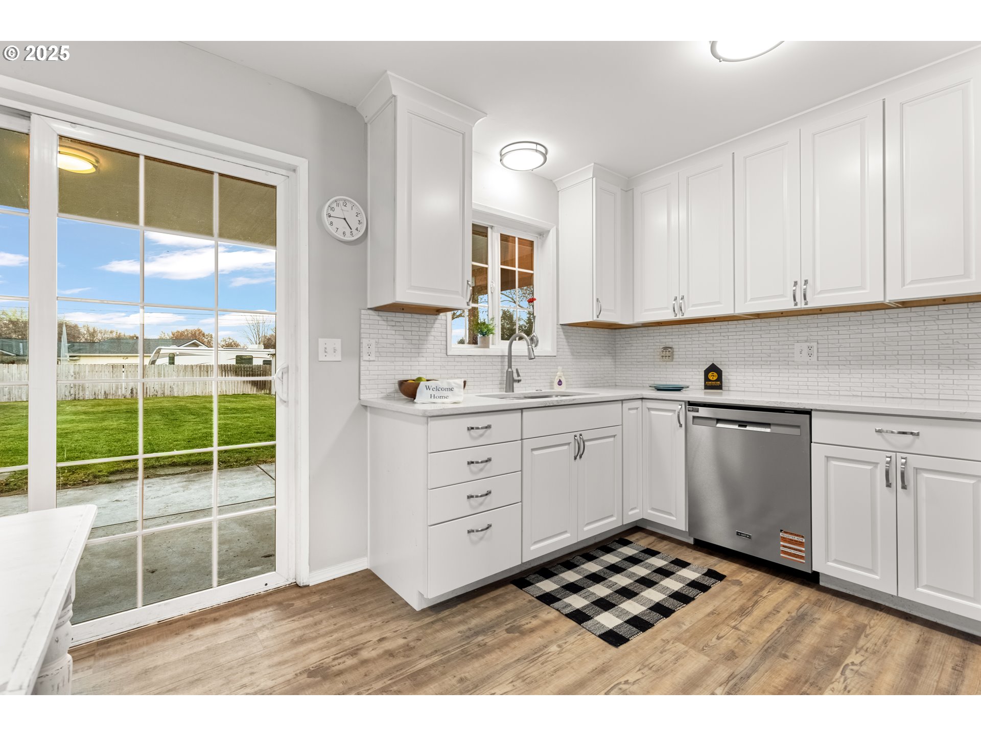 4207 Southwest Sheridan Avenue Pendleton, OR 97801 - Photo 13 of 34 a kitchen with a refrigerator sink and wooden cabinets