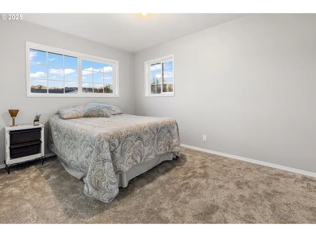 a bedroom with a bed a table and chair