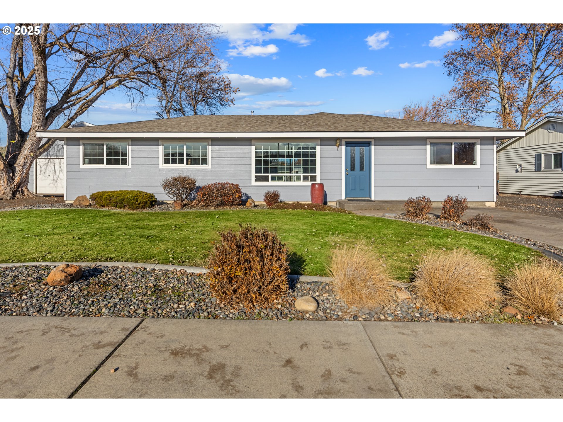 4207 Southwest Sheridan Avenue Pendleton, OR 97801 - Photo 6 of 34 a view of a yard in front of a house with a large tree