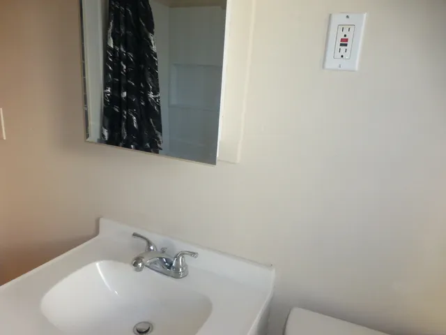 a bathroom with a sink and a mirror