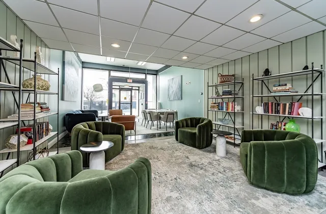 a living room with furniture and a book shelf