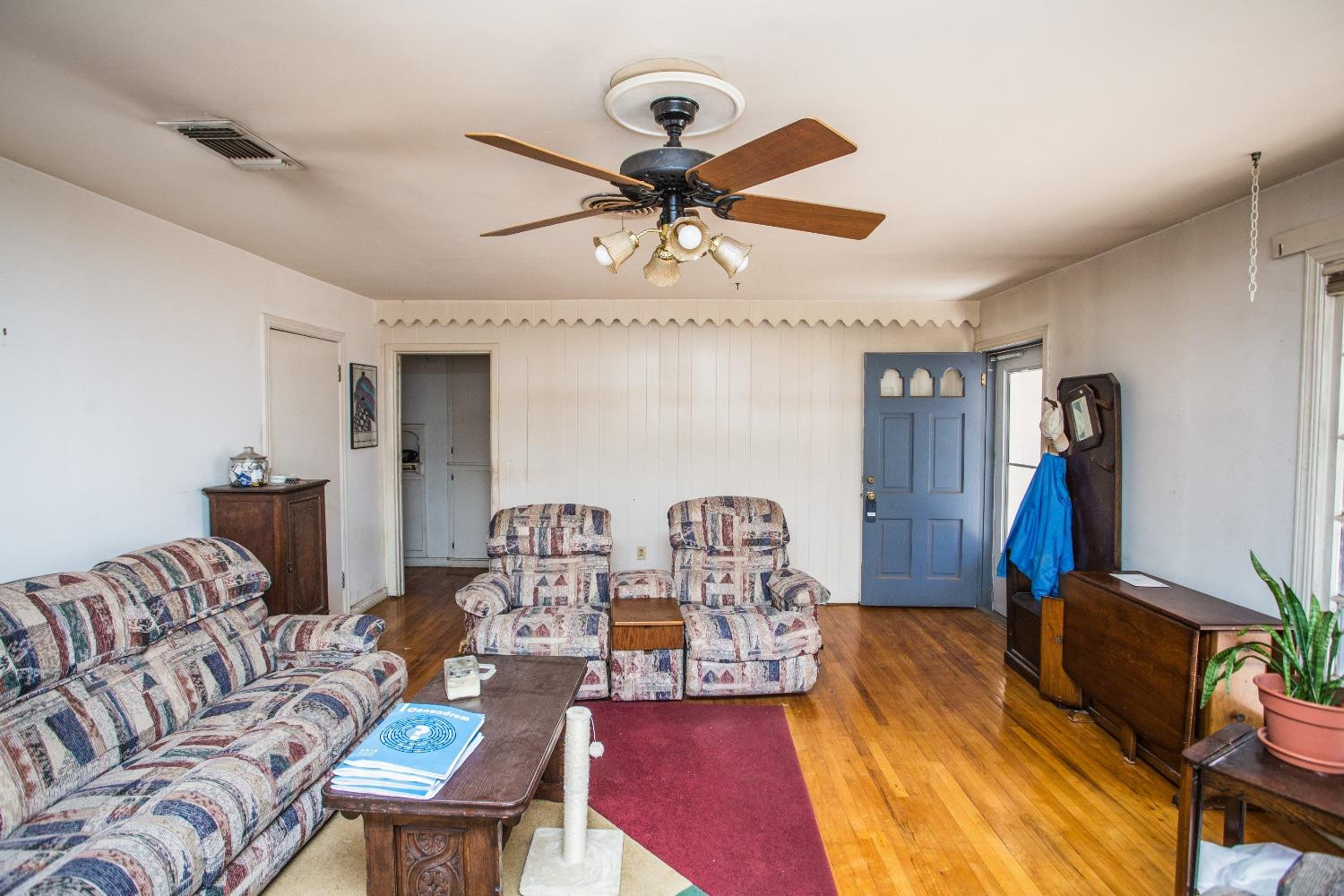 2422 33rd Street Lubbock, TX 79411 - Photo 11 of 35 a living room with furniture a rug and a chandelier