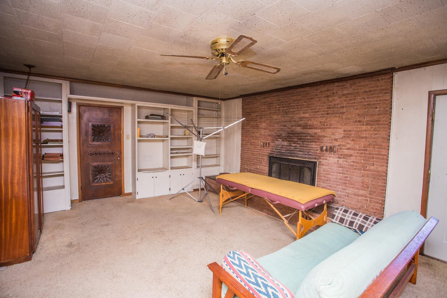 2422 33rd Street Lubbock, TX 79411 - Photo 17 of 35 a bedroom with furniture and a ceiling fan